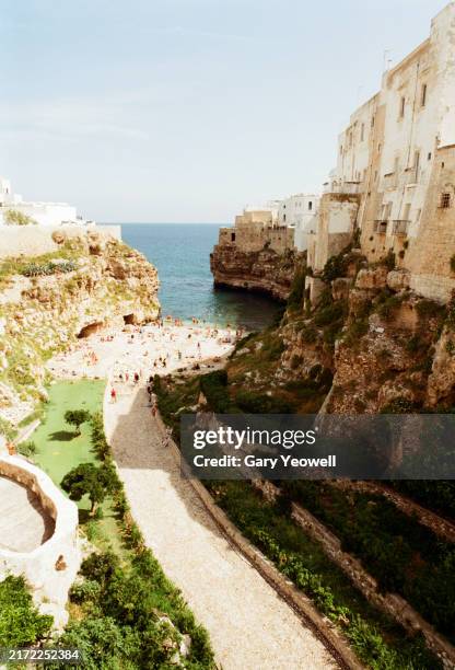 beach by coastal town of polignano a mare - heavy stone stock pictures, royalty-free photos & images