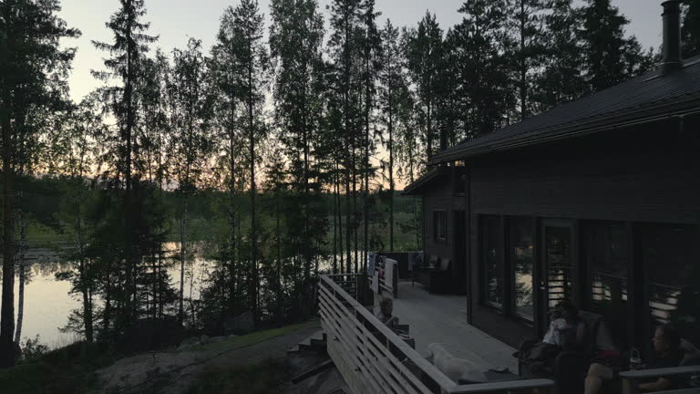 https://media.gettyimages.com/id/2172287671/video/family-relaxing-on-a-cabin-deck-by-the-lake-surrounded-by-trees-at-sunset.jpg?b=1&s=640x640&k=20&c=4b4xNfs3RpyFJ-EuJr_SlG_OoOatiTahCnaVoYpGlKQ=