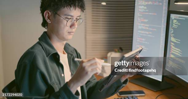 man using digital tablet for coding at desk. - java code stock pictures, royalty-free photos & images