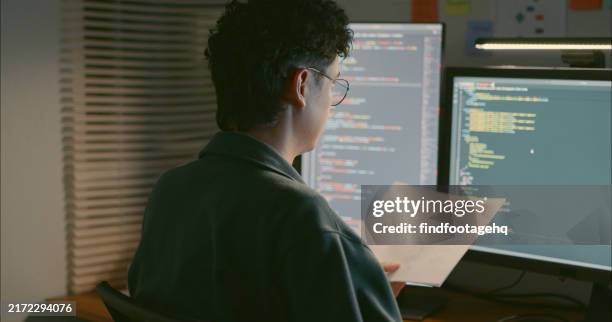 software developer reviewing code and diagrams. - java code stock pictures, royalty-free photos & images