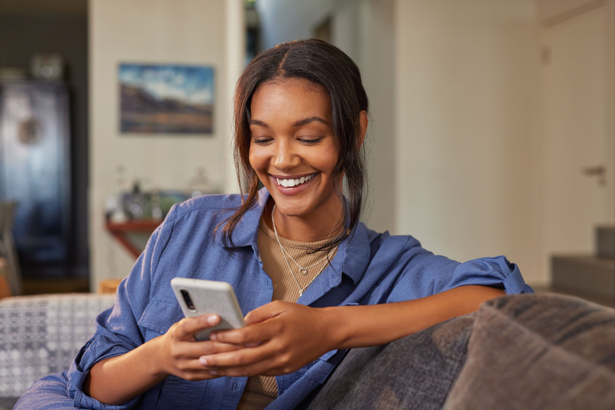 Beautiful multiethnic woman using phone at home Beautiful multiethnic woman using phone at home