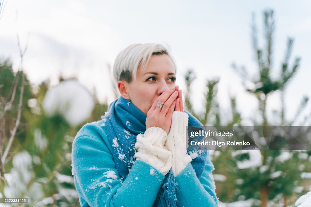 Cold walk. Woman shivers after freezing winter stroll in park