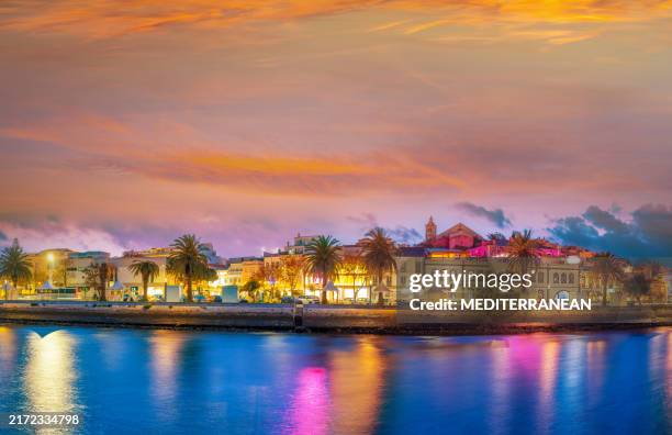 stunning sunset over lagos downtown skyline reflecting on water in algarve, portugal - faro district portugal stock pictures, royalty-free photos & images