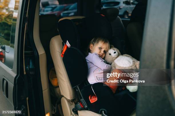 toddler is sad while sitting in a car seat - baby pout stock pictures, royalty-free photos & images