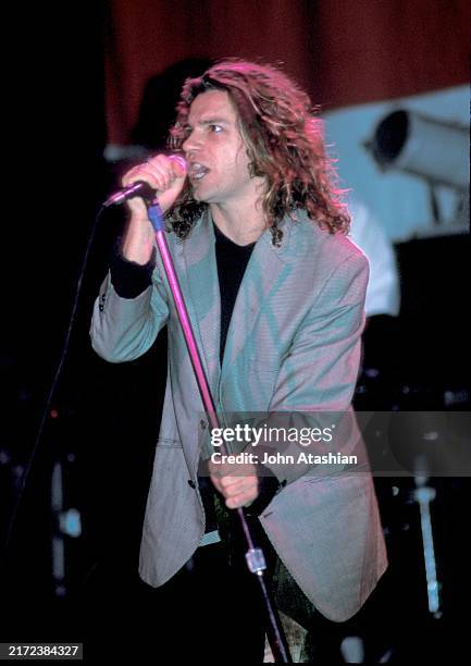 Singer, songwriter and actor Michael Hutchence is shown performing on stage during a live concert appearance with INXS on November 6, 1987 in...