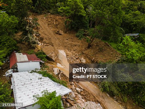Aerial view Landslide impacting hillside village in dense forest Aerial view Landslide impacting hillside village in dense forest