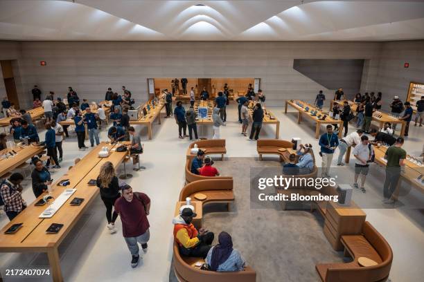 Customers during the first day of in-store sales of Apple's latest products at Apple's Fifth Avenue store in New York, US, on Friday, Sept. 20, 2024....