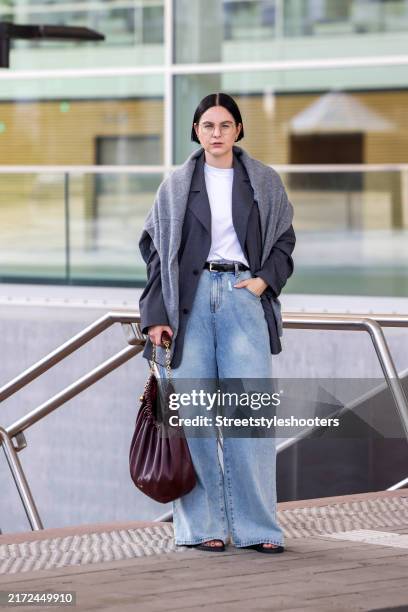 Art director Maria Barteczko, wearing agrey oversize blazer by Badblood, a grey over the shoulder sweater by Gitta Banko The Label, a white oversize...