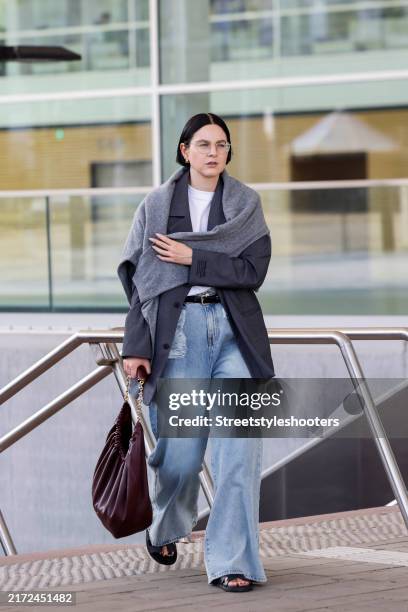 Art director Maria Barteczko, wearing agrey oversize blazer by Badblood, a grey over the shoulder sweater by Gitta Banko The Label, a white oversize...