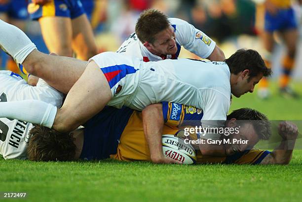 Wayne McDonald of Leeds Rhinos is hauled down by the Wakefield Trinity Wildcats defence during the Tetley's Bitter Super League match between the...