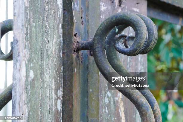 wrought iron on the wood fence - old abandoned mansions stock pictures, royalty-free photos & images