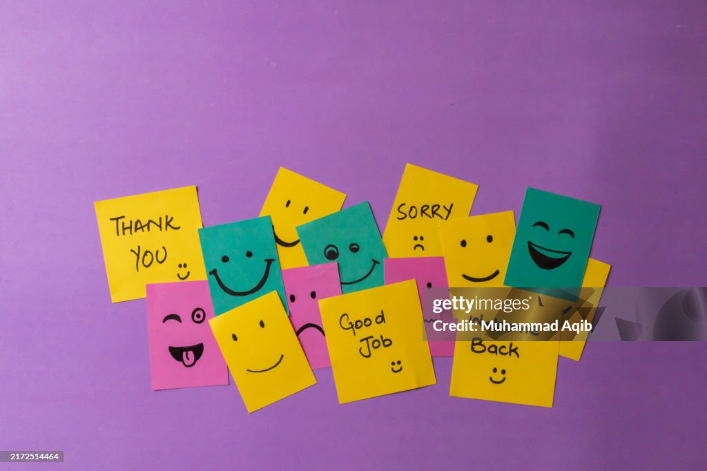 Mixed smileys on sticky notes, purple background