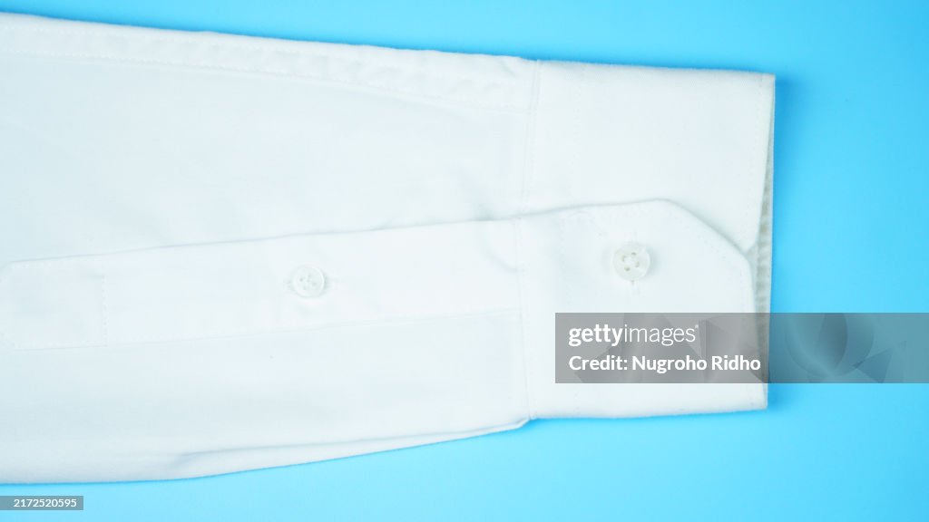 White Shirt Long Sleeve Close up on Blue Background