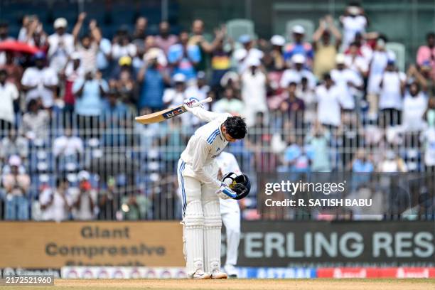 India's Shubman Gill gestures to the crowd as he celebrates after scoring a century during the third day of the first Test cricket match between...