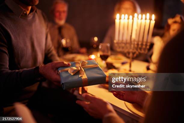 traditional gift exchanging on hanukkah! - hanukkah stock pictures, royalty-free photos & images