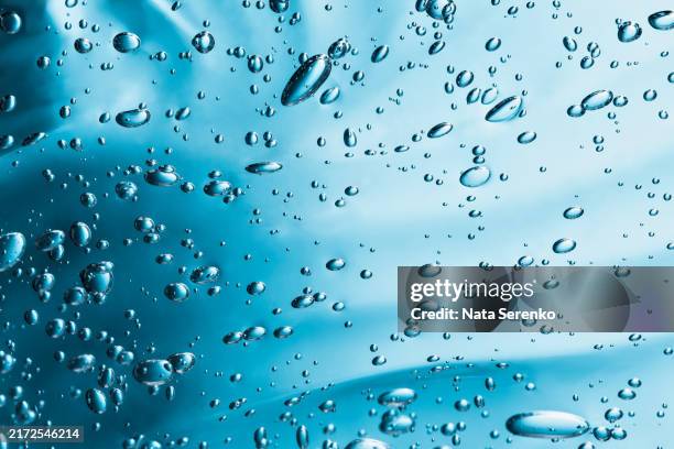 close up macro aloe vera gel serum cosmetic texture blue background with bubbles. - jojoba stock pictures, royalty-free photos & images