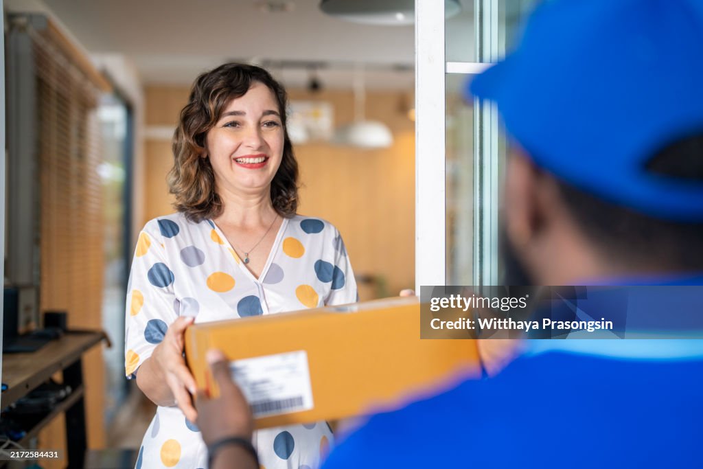 Courier person making a delivery to a customer at home.