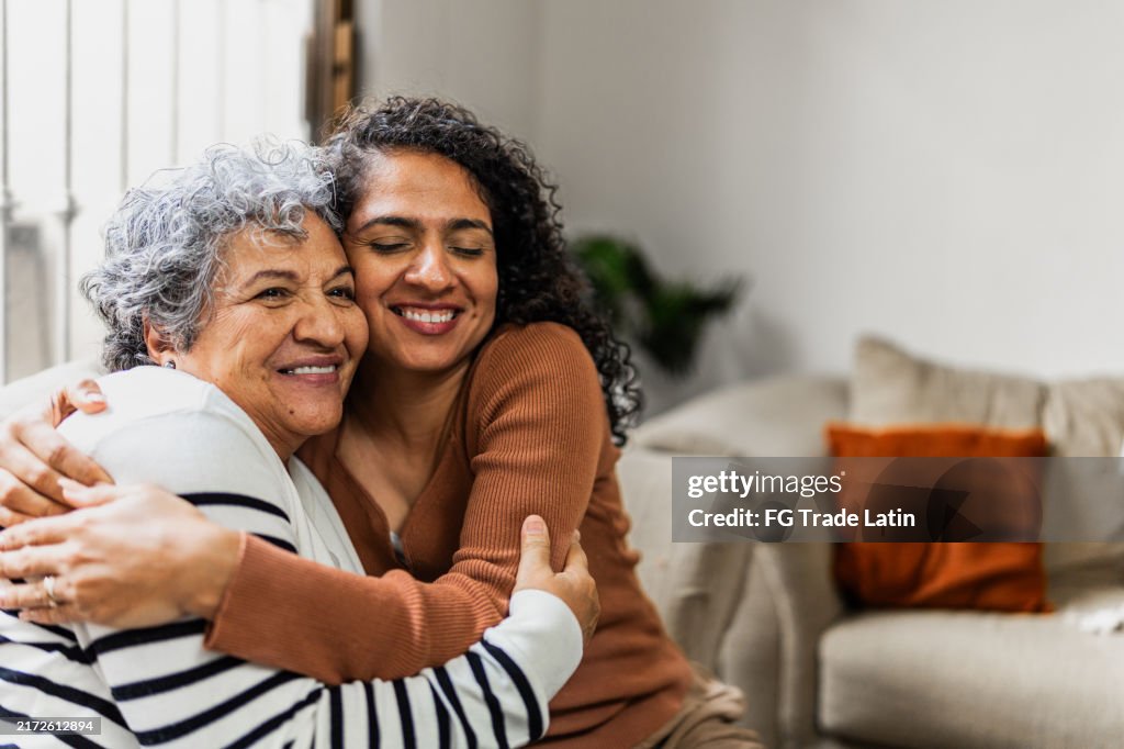 Mother and daughter embraced at home