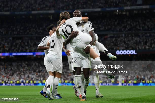 Antonio Ruediger of Real Madrid celebrates scoring his team's second goal with teammate Luka Modric during the UEFA Champions League 2024/25 League...