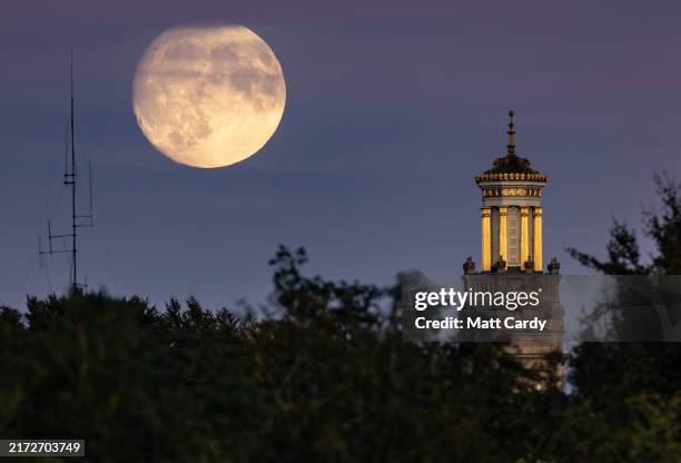 The almost full harvest supermoon rises behind the recently restored Beckford's Tower on September 16, 2024 in Bath, England. Tonight's supermoon, so...