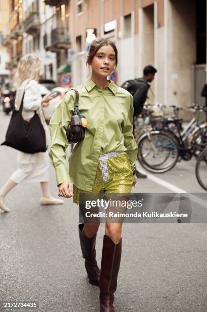 Sasha Sviridovskaya wears green shirt, green glitter shorts, brown bag and brown shoes outside Iceberg show during the Milan Fashion Week...