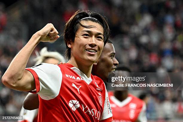Reims' Japanese forward Keito Nakamura celebrates scoring his team's first goal during the French L1 football match between Stade de Reims and Paris...