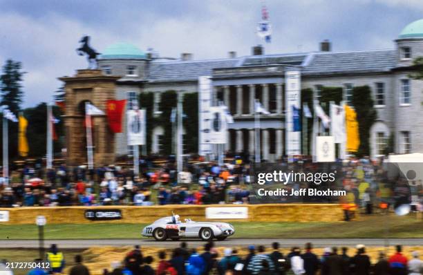Sir Stirling Moss passes Goodwood House in a Mercedes 300 SLR during the Goodwood Festival of Speed at Goodwood House & Estate, West Sussex, England...