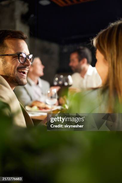 happy business couple talking on a lunch in a restaurant. - after work stock pictures, royalty-free photos & images