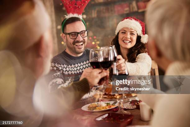 celebratory toast during christmas dinner time! - christmas dinner stockfoto's en -beelden