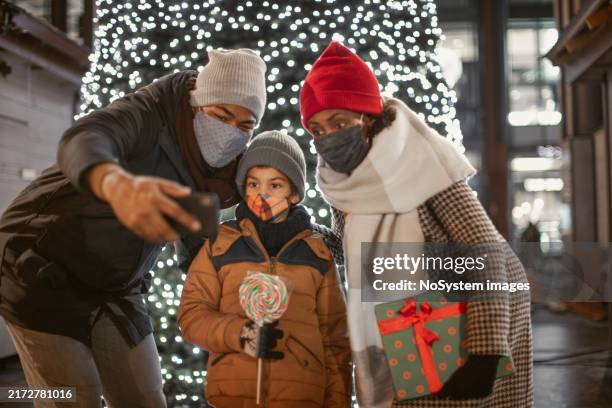 family selfie by christmas tree lights - mom son facial stock pictures, royalty-free photos & images