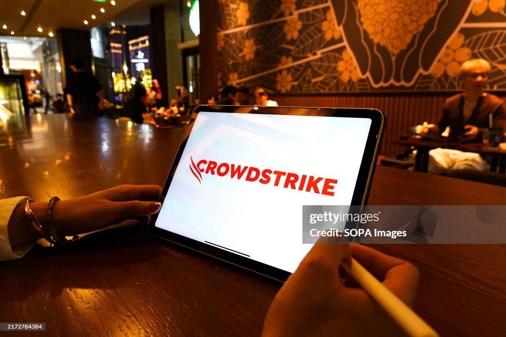 In this photo illustration, a CrowdStrike logo is displayed...