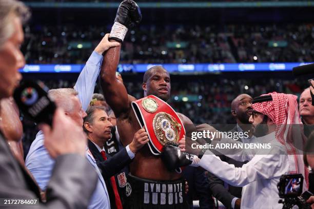 Britain's Daniel Dubois celebrates after defeating Britain's Anthony Joshua during their heavyweight boxing match for the IBF world title at Wembley...