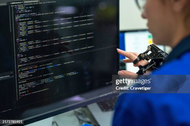 ai-powered robotic arm synchronized with expert coding. explore advanced tech and innovation in an assembly room focused on pushing the limits of robotics and digital transformation. - python code stock pictures, royalty-free photos & images