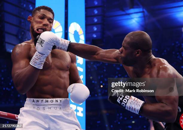Daniel Dubois punches Anthony Joshua in the first round of their the IBF World Heavyweight Title fight at the Riyadh Season - Wembley Edition card at...