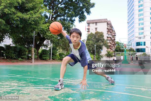 cute asian boy playing basketball - basketball competition stock pictures, royalty-free photos & images