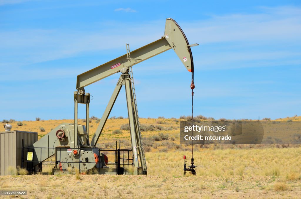 Ölbohrturm - Pumpenheber / nickender Esel, Ölquelle in den Ebenen von Wyoming, USA - ikonisches Symbol der Erdölförderung