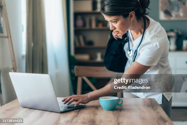 doctor at home ready for work shift. - shift work stock pictures, royalty-free photos & images
