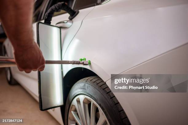 repairing car dent after the accident by paintless dent repair - dented stock pictures, royalty-free photos & images