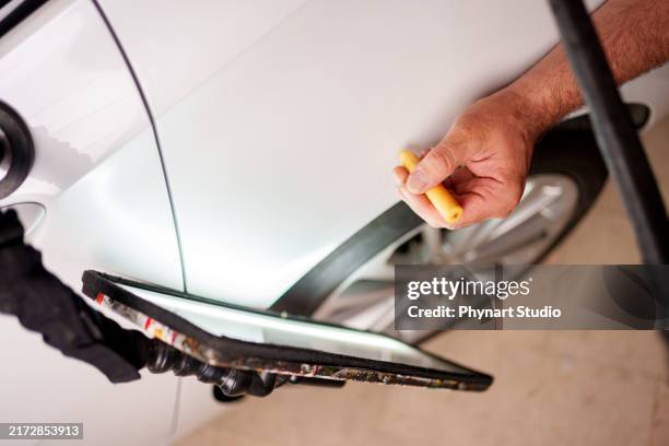 repairing dents on car body - verbeult stock-fotos und bilder