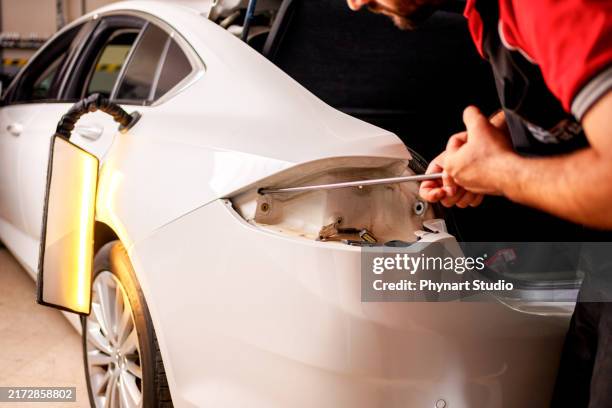 unpainted car dent correction process, bodywork dent correction, hail, door dent - dented stock pictures, royalty-free photos & images