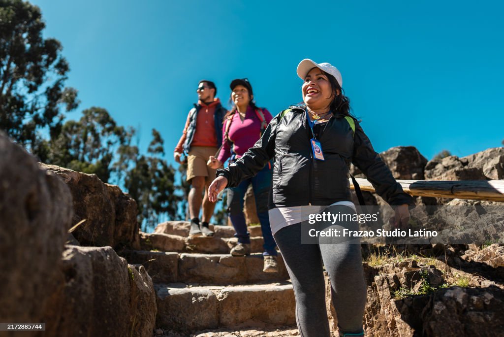 Tour guide woman talking with tourists in Cusco, Peru