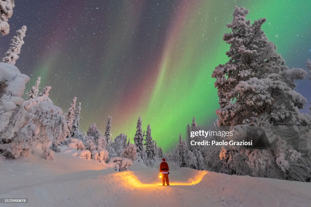 Santa Claus admiring northern lights