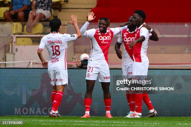 Monaco's Dutch defender Jordan Teze celebrates with teammates after scoring his team's first goal during the French L1 football match between AS...