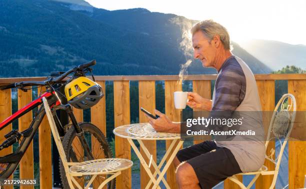 mature man enjoys coffee on cabin veranda - early retirement stock pictures, royalty-free photos & images