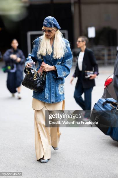 Guest is seen wearing a denim hat, a denim printed kimono, denim ballerinas, beige trousers and a black leather crossbody bag outside Antonio Marras...