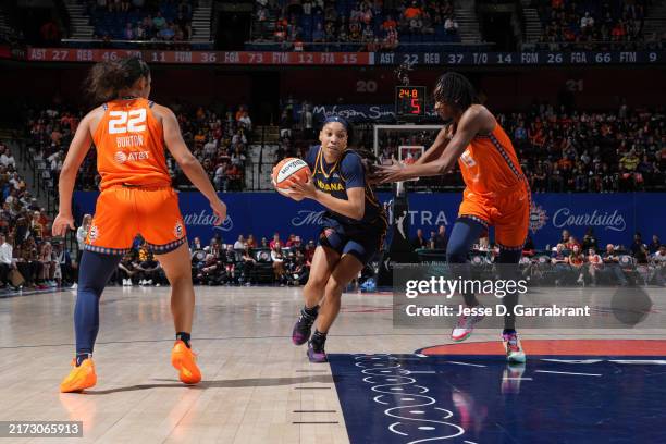 Victaria Saxton of the Indiana Fever dribbles the ball during the game against the Connecticut Sun during round one game one of the 2024 WNBA...