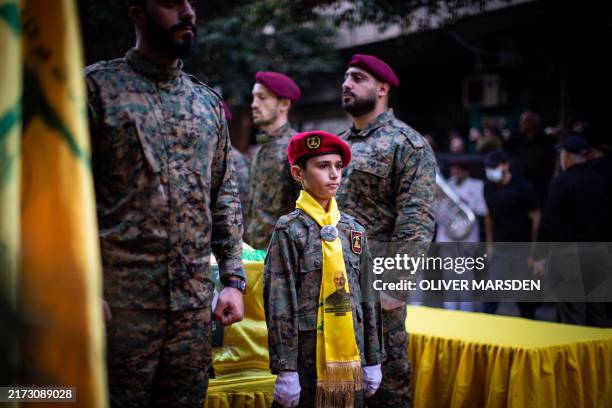 Young boy mourns at the funeral of Ibrahim Aqil, the Hezbollah Radwan Forces commander, and Mahmoud Hamad, another Hezbollah commander, both killed...