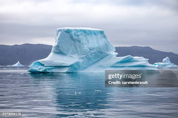 iceberg in a greenlandic fjord - floating on water stock pictures, royalty-free photos & images