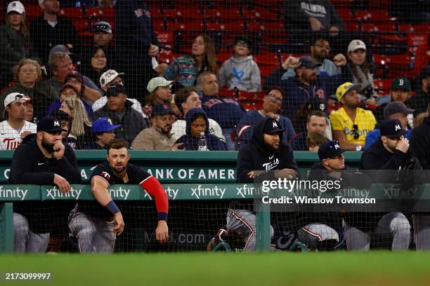 Minnesota Twins players hang on the railing at the dugout during the eighth inning of their 9-3 loss to the Boston Red Sox in game two of a...