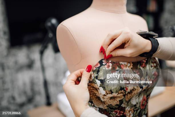hands of unrecognizable female tailor with magnetic bracelet for pins breathe life into feminine corset - needlecraft product stock pictures, royalty-free photos & images